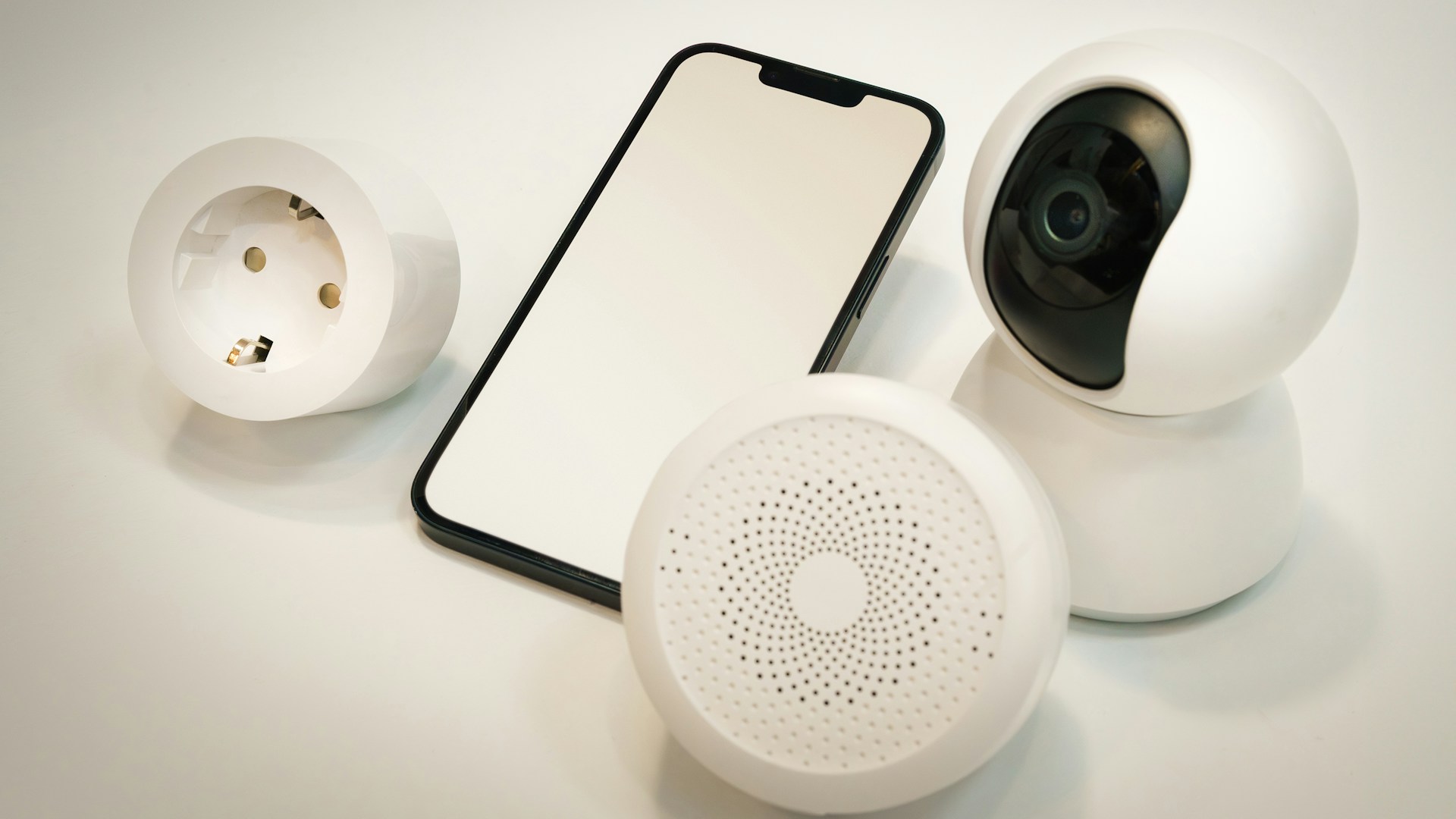 A cell phone and a camera sitting on a table