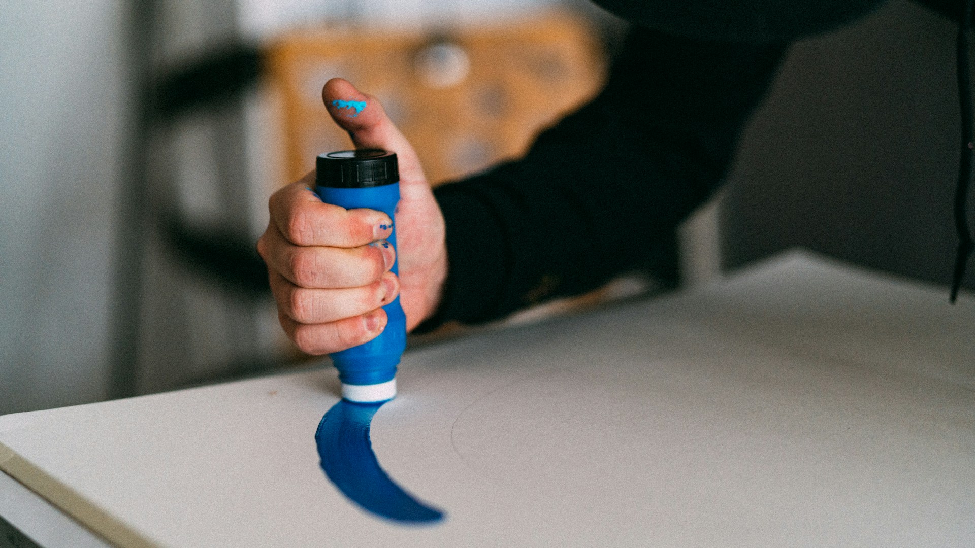 person holding blue and black plastic toy