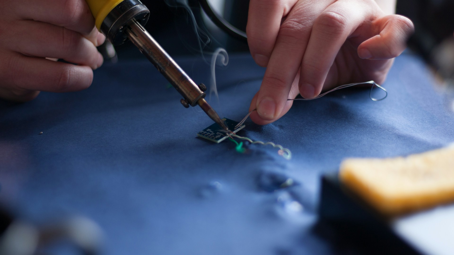 person using soldering iron