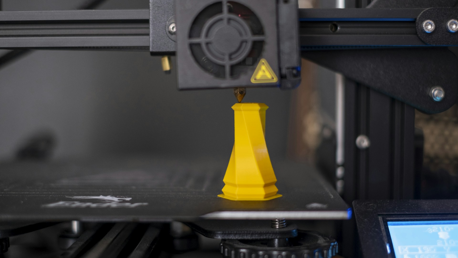 a 3d printer with a yellow cone on top of it