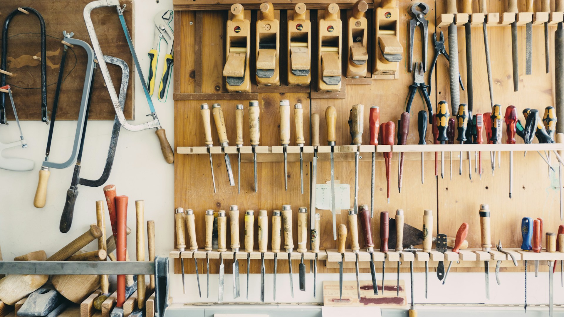 assorted handheld tools in tool rack